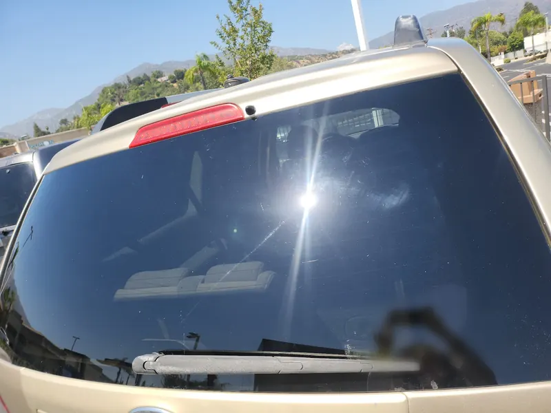 New rear window glass installed on a tan SUV