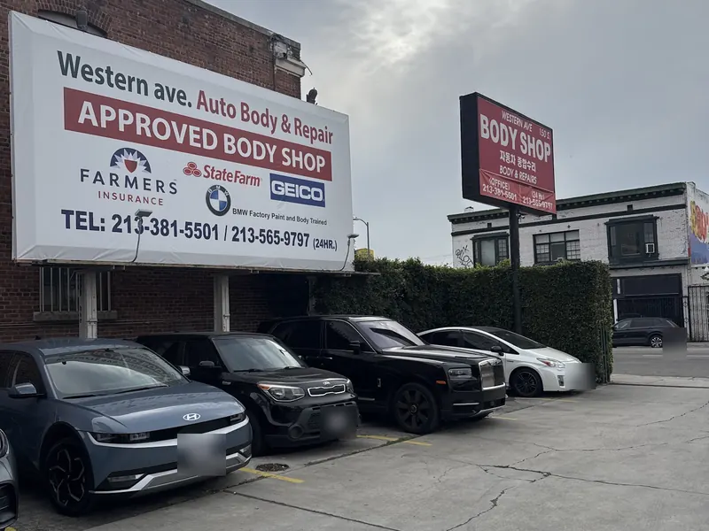 Approved body shop billboard on Western Ave showing State Farm, Geico and Farmers logos